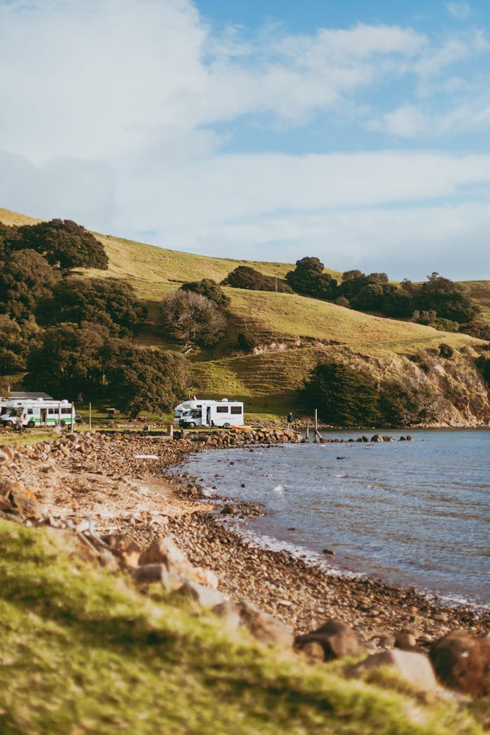 services-03 Explore the serene coastline of Coromandel with RVs parked by the sea.