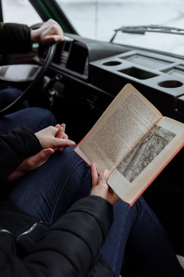 about-02 A couple enjoying a book inside a campervan on their road trip adventure.